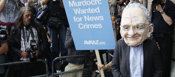 A protester wearing a Rupert Murdoch mask is photographed by media outside parliament in London, Tuesday, July 19, 2011. A protester wearing a Rupert Murdoch mask is photographed by media outside parliament in London, Tuesday, July 19, 2011. - Sputnik International