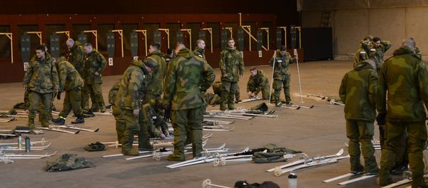 Soldiers and Airmen with the Minnesota National Guard begin the process of adjusting the binding mechanics on their Nordic skis at Camp Vaernes, Norway, on Feb. 11, 2017. - Sputnik International