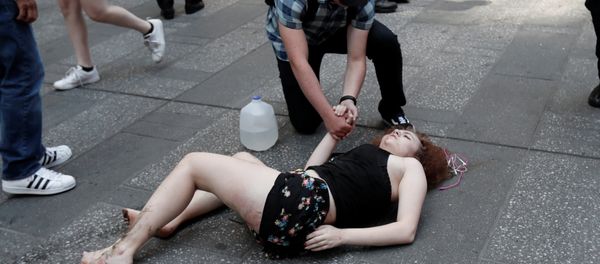 An injured woman lays on the sidewalk in Times Square after a speeding vehicle struck pedestirans on the sidewalk inn New York City, U.S., May 18, 2017 An injured woman lays on the sidewalk in Times Square after a speeding vehicle struck pedestirans on the sidewalk inn New York City, U.S., May 18, 2017 - Sputnik International