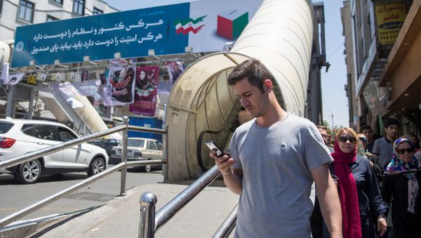 A man uses his smartphone to follow election news in Tehran, Iran May 17, 2017 A man uses his smartphone to follow election news in Tehran, Iran May 17, 2017 - Sputnik International
