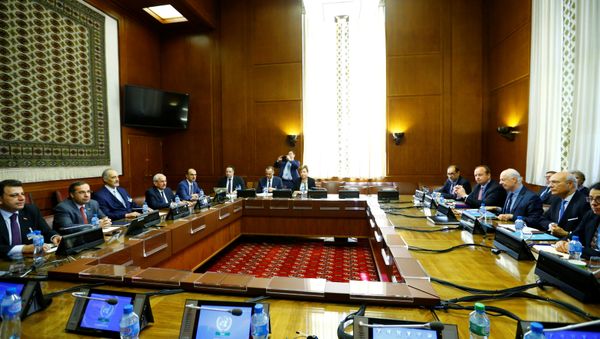 United Nations Special Envoy for Syria Staffan de Mistura and Syrian government negotiator Bashar Ja'afari attend a meeting during Intra Syria talks along with their delegations at the U.N. in Geneva, Switzerland, May 16, 2017 - Sputnik International