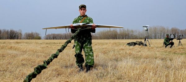 A serviceman of the reconnaissance unit of an Eastern Military District motorized rifle formation launches a drone during special tactical training at the Anastasyevsky base in the Khabarovsk Territory A serviceman of the reconnaissance unit of an Eastern Military District motorized rifle formation launches a drone during special tactical training at the Anastasyevsky base in the Khabarovsk Territory - Sputnik International
