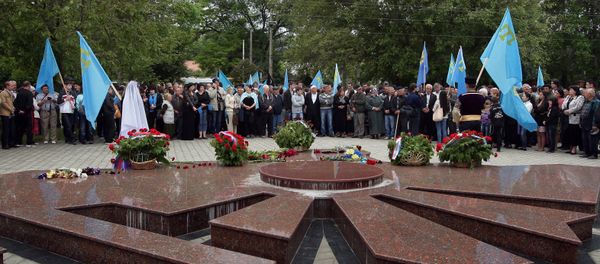 People conducting a prayer service at the monument to deported peoples in Simferopol during events marking the 70th anniversary of the deportation of the Crimean Tatars People conducting a prayer service at the monument to deported peoples in Simferopol during events marking the 70th anniversary of the deportation of the Crimean Tatars - Sputnik International