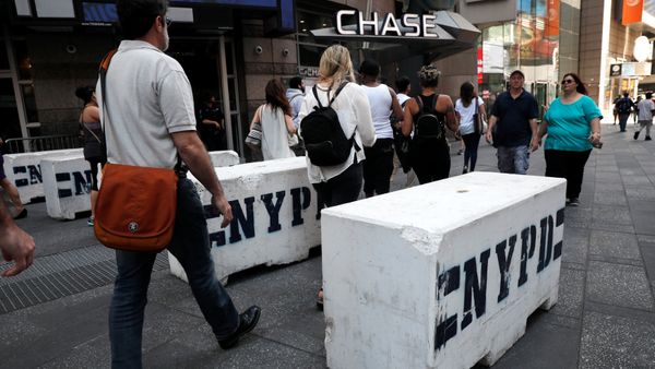 People walk between newly erected concrete barricades outside the 3 Times Square building in Times Square where a speeding vehicle struck pedestrians Thursday in New York City, U.S., May 19, 2017 - Sputnik International