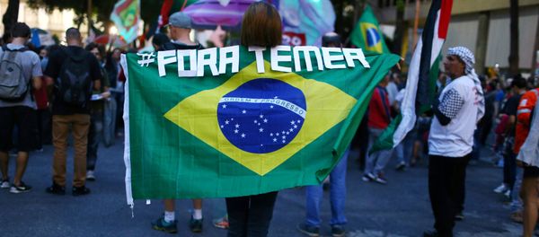 A demonstrator carries a Brazilian national flag as she attends a protest against Brazil's President Michel Temer in Rio de Janeiro, Brazil, May 18, 2017 - Sputnik International