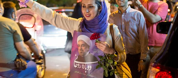 A woman holds a poster of Iranian President Hassan Rouhani during a campaign rally in Tehran, Iran, May 17, 2017 A woman holds a poster of Iranian President Hassan Rouhani during a campaign rally in Tehran, Iran, May 17, 2017 - Sputnik International