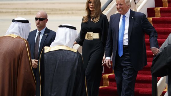 U.S. President Donald Trump, accompanied by first lady Melania Trump, smiles at Saudi King Salman, left, upon his arrival at a welcome ceremony at the Royal Terminal of King Khalid International Airport, Saturday, May 20, 2017, in Riyadh. - Sputnik International