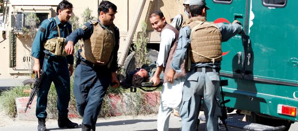 Afghan policemen transport a dead body of a police after gunmen attack in Jalalabad city eastern Afghanistan May 17, 2017 - Sputnik International
