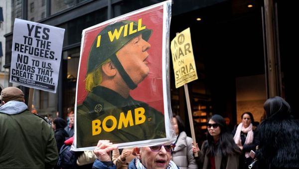 Anti-war protesters shout slogans against US President Donald Trump during a demonstration in front of the Trump Tower in New York on April 7, 2017, to protest the US air strike in Syria Anti-war protesters shout slogans against US President Donald Trump during a demonstration in front of the Trump Tower in New York on April 7, 2017, to protest the US air strike in Syria - Sputnik International