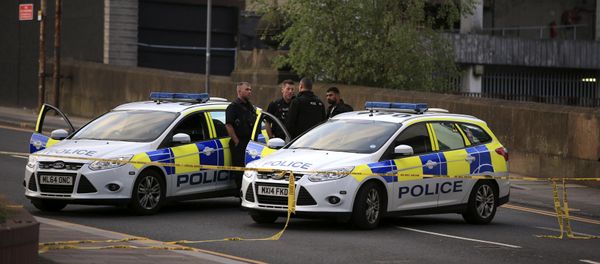 Police officers stand next to their vehicles near the Manchester Arena after a blast at Ariana Grande concert Tuesday May 23, 2017 - Sputnik International