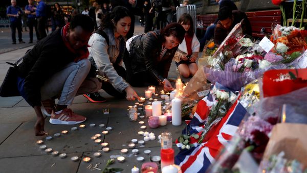 Women light candles for the victims of the Manchester Arena attack, in central Manchester, May 23, 2017. Women light candles for the victims of the Manchester Arena attack, in central Manchester, May 23, 2017. - Sputnik International