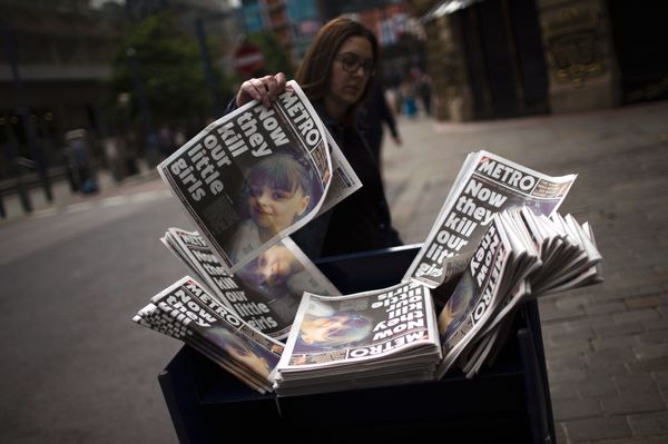 A woman picks a newspaper reporting the news on the suicide attack at a concert by Ariana Grande that killed more than 20 people as it ended Monday night in central Manchester, Britain, Wednesday, May 24, 2017. A woman picks a newspaper reporting the news on the suicide attack at a concert by Ariana Grande that killed more than 20 people as it ended Monday night in central Manchester, Britain, Wednesday, May 24, 2017. - Sputnik International