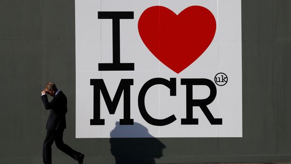 A man walks past a sign in central Manchester, Britain May 25, 2017. - Sputnik International