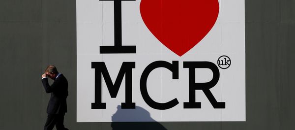 A man walks past a sign in central Manchester, Britain May 25, 2017. A man walks past a sign in central Manchester, Britain May 25, 2017. - Sputnik International