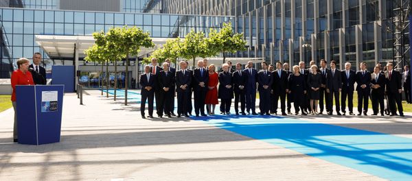 German Chancellor Angela Merkel (L) speaks beside NATO Secretary General Jens Stoltenberg and NATO members leaders at the start of the NATO summit at their new headquarters in Brussels, Belgium - Sputnik International