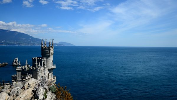 Swallow's Nest is a monument of architecture on top of the Aurora Cliff overlooking the Cape of Ai-Todor in Yalta, the Crimea. (File) Swallow's Nest is a monument of architecture on top of the Aurora Cliff overlooking the Cape of Ai-Todor in Yalta, the Crimea. (File) - Sputnik International