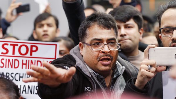 A demonstrator shouts during a protest against the deportation of 50 Afghan asylum seekers at the airport in Frankfurt, Germany, Wednesday, Dec. 14, 2016. - Sputnik International