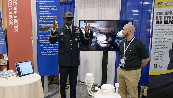 Maj. Gen. Cedric Wins, commanding general of the US Army Research, Development and Engineering Command, uses hand motions in an augmented reality demo under the guidance of ECBC Animation Team Lead Jason Gitlin. - Sputnik International