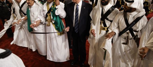 President Donald Trump holds a sword and sways with traditional dancers during a welcome ceremony at Murabba Palace in Riyadh President Donald Trump holds a sword and sways with traditional dancers during a welcome ceremony at Murabba Palace in Riyadh - Sputnik International