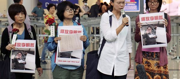 Li Ching-yu, center right, wife of Taiwanese pro-democracy activist Li Ming-che detained in China, gives a press conference after she was denied boarding the flight to Beijing at the airport counter at Taoyuan international airport in Taoyuan, Taiwan Monday, April 10, 2017. - Sputnik International