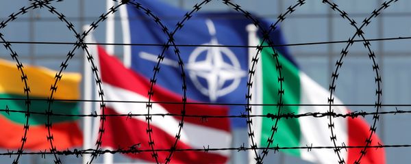 The NATO flag is seen through barbed wire as it flies in front of the new NATO Headquarters in Brussels, Belgium May 24, 2017 The NATO flag is seen through barbed wire as it flies in front of the new NATO Headquarters in Brussels, Belgium May 24, 2017 - Sputnik International