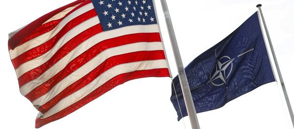 NATO and U.S. flags fly at the entrance of the Alliance's headquarters during a NATO foreign ministers meeting in Brussels, Belgium March 31, 2017 - Sputnik International