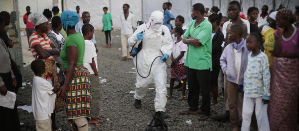 In this file photo daetd Tuesday, Sept. 30, 2014, a medical worker sprays people being discharged from the Island Clinic Ebola treatment center in Monrovia, Liberia In this file photo daetd Tuesday, Sept. 30, 2014, a medical worker sprays people being discharged from the Island Clinic Ebola treatment center in Monrovia, Liberia - Sputnik International