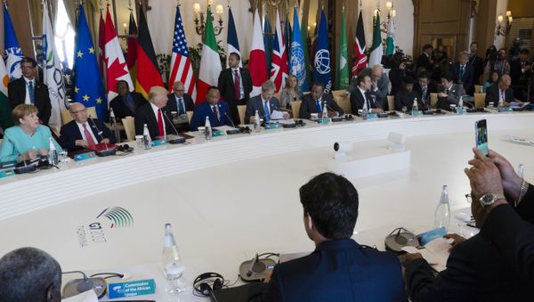 German Chancellor Angela Merkel, rear left, and and U.S. President Donald Trump, rear third left, attend a round table meeting of G7 leaders and Outreach partners at the Hotel San Domenico during a G7 summit in Taormina, Italy, Saturday, May 27, 2017 - Sputnik International