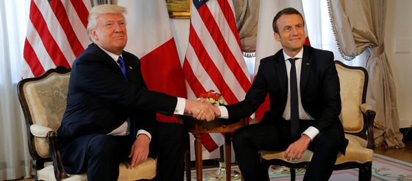 U.S. President Donald Trump (L) and French President Emmanuel Macron shake hands before a lunch ahead of a NATO Summit in Brussels, Belgium, May 25, 2017 - Sputnik International