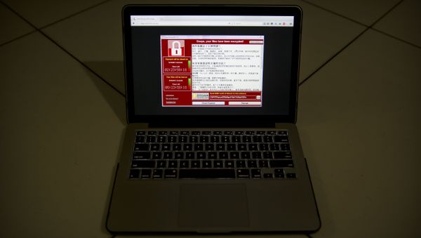 A screenshot of the warning screen from a purported ransomware attack, as captured by a computer user in Taiwan, is seen on laptop in Beijing, Saturday, May 13, 2017. - Sputnik International