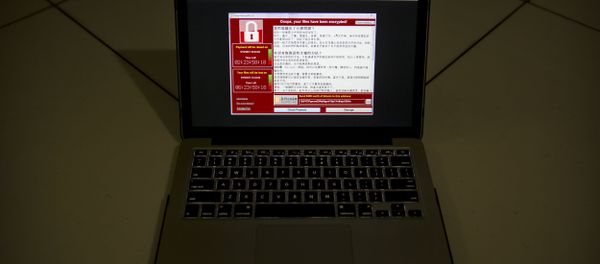 A screenshot of the warning screen from a purported ransomware attack, as captured by a computer user in Taiwan, is seen on laptop in Beijing, Saturday, May 13, 2017. A screenshot of the warning screen from a purported ransomware attack, as captured by a computer user in Taiwan, is seen on laptop in Beijing, Saturday, May 13, 2017. - Sputnik International