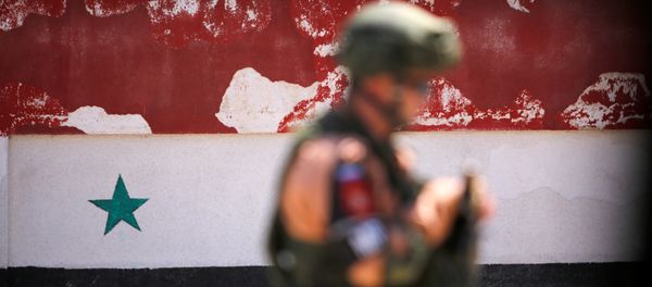 A Russian soldier stands guard near a Syrian national flag drawn on the wall as rebel fighters and their families evacuate the besieged Waer district in the central Syrian city of Homs, after an agreement reached between rebels and Syria's army, Syria May 21, 2017 A Russian soldier stands guard near a Syrian national flag drawn on the wall as rebel fighters and their families evacuate the besieged Waer district in the central Syrian city of Homs, after an agreement reached between rebels and Syria's army, Syria May 21, 2017 - Sputnik International