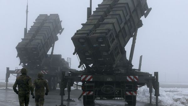 Two soldiers run toward Patriot antimissile systems Two soldiers run toward Patriot antimissile systems - Sputnik International