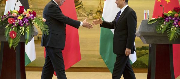 Palestinian Foreign Minister Riyad Al-Maliki, left, and Chinese Foreign Minister Wang Yi reach to shake hands at the end of their joint press conference at the Ministry of Foreign Affairs in Beijing, Thursday, April 13, 2017. Palestinian Foreign Minister Riyad Al-Maliki, left, and Chinese Foreign Minister Wang Yi reach to shake hands at the end of their joint press conference at the Ministry of Foreign Affairs in Beijing, Thursday, April 13, 2017. - Sputnik International