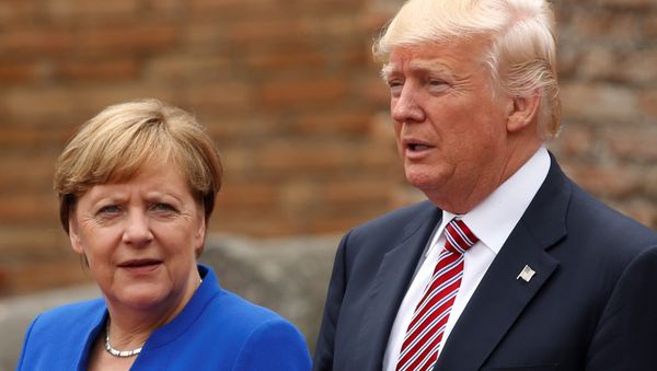 US President Donald Trump and German Chancellor Angela Merkel pose during a family photo at the Greek Theatee during a G7 summit in Taormina, Sicily, Italy, May 26, 2017. - Sputnik International