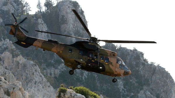A Turkish army Cougar helicopter flies over the Saint-Hilarion mountain shane near Kyrenia during a search and rescue exercise in northern Cyprus, Tuesday, June 16, 2009 amid a dispute with Greek Cypriots over oil and gas exploration off the island. A Turkish army Cougar helicopter flies over the Saint-Hilarion mountain shane near Kyrenia during a search and rescue exercise in northern Cyprus, Tuesday, June 16, 2009 amid a dispute with Greek Cypriots over oil and gas exploration off the island. - Sputnik International