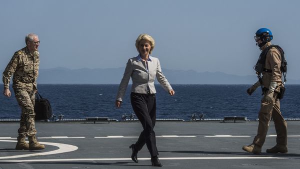 German Defence Minister Ursula von der Leyen walks along the landing pad after landing on the German navy support ship of the German navy support ship Bonn, in the Aegean Sea, off the Turkish coast on April 20, 2016. - Sputnik International