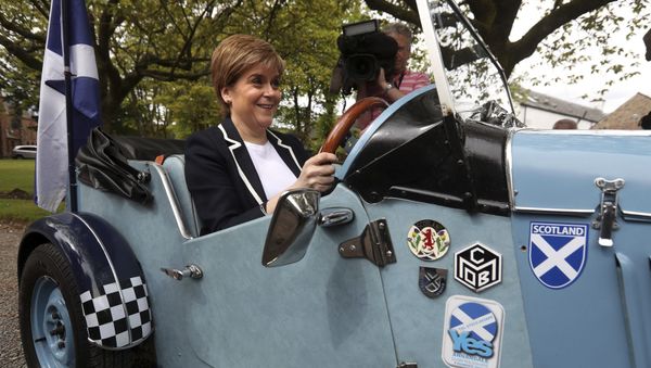 Scotland's First Minister and SNP leader Nicola Sturgeon sits in the driving seat of a Midge car during a campaign visit to Moffat, Scotland, on Friday May 19, 2017. Scotland's First Minister and SNP leader Nicola Sturgeon sits in the driving seat of a Midge car during a campaign visit to Moffat, Scotland, on Friday May 19, 2017. - Sputnik International