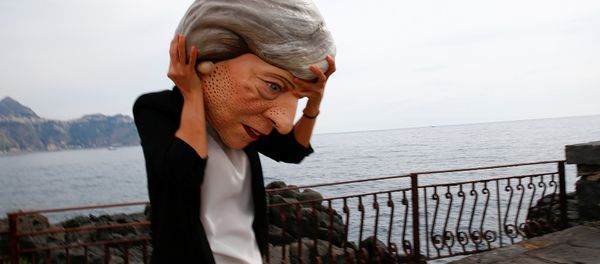 A protester wears a mask depicting Britain's Prime Minister Theresa May during a demonstration organised by Oxfam in Giardini Naxos, Sicily, Italy, May 25, 2017. - Sputnik International