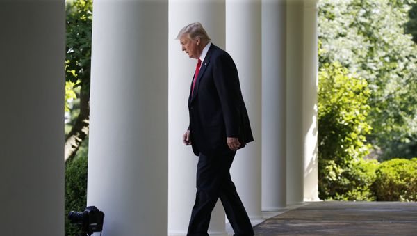 U.S. President Donald Trump enters the Rose Garden from the White House colonnade to announce his decision to leave the Paris Climate Agreement in the Rose Garden of the White House in Washington, U.S., JJune 1, 2017 - Sputnik International