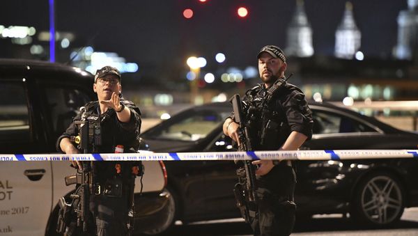 Armed Police officers stand guard on London Bridge in central London, Saturday, June 3, 2017. Armed Police officers stand guard on London Bridge in central London, Saturday, June 3, 2017. - Sputnik International