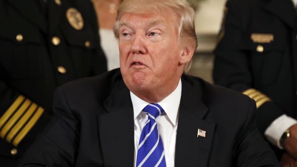 President Donald Trump, flanked by members of law enforcement, speaks before signing bills in the Diplomatic Reception Room at the White House - Sputnik International