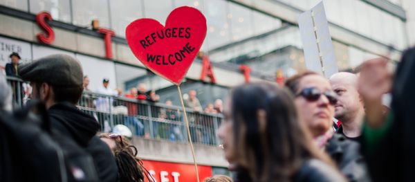 People hold signs reading 'refugees welcome' as they take part in demonstration in solidarity with migrants seeking asylum in Europe after fleeing their home countries in Stockholm (File) - Sputnik International