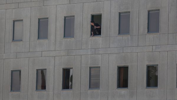 An Iranian policeman looks out of the parliament's building in central Tehran, Iran, June 7, 2017 - Sputnik International