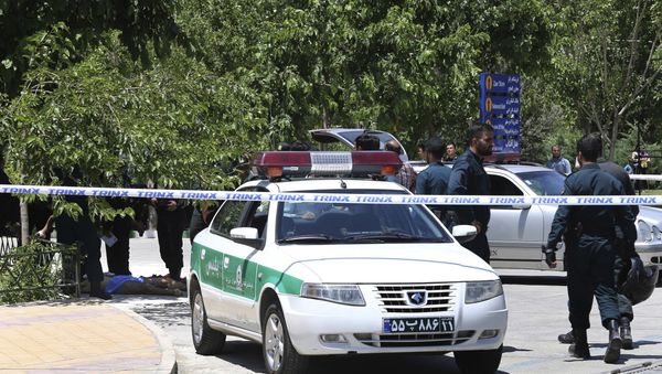 The body of a suspected terrorist, at background left, lies on the ground while police control the scene at the shrine of late Iranian revolutionary founder Ayatollah Khomeini, just outside Tehran, Iran, Wednesday, June 7, 2017 - Sputnik International
