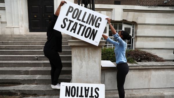 Workers prepare signs outside their polling station on general election day in London, britain, June 8, 2017. Workers prepare signs outside their polling station on general election day in London, britain, June 8, 2017. - Sputnik International