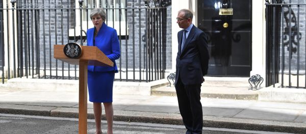 Britain's Prime Minister and leader of the Conservative Party Theresa May, (L), accompanied by her husband Philip, delivers a statement outside 10 Downing Street in central London on June 9, 2017 as results from a snap general election show the Conservatives have lost their majority. Britain's Prime Minister and leader of the Conservative Party Theresa May, (L), accompanied by her husband Philip, delivers a statement outside 10 Downing Street in central London on June 9, 2017 as results from a snap general election show the Conservatives have lost their majority. - Sputnik International