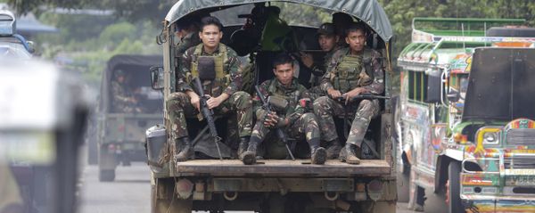 In this June 9, 2017, photo, soldiers ride a military vehicle on the outskirts of Marawi city, southern Philippines. The Philippine military says 13 marines have been killed in fierce fighting with Muslim militants who have laid siege to southern Marawi city. In this June 9, 2017, photo, soldiers ride a military vehicle on the outskirts of Marawi city, southern Philippines. The Philippine military says 13 marines have been killed in fierce fighting with Muslim militants who have laid siege to southern Marawi city. - Sputnik International