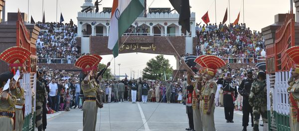 In this July 21, 2015 file photo, Indian and Pakistani flags are lowered during a daily retreat ceremony at the India-Pakistan joint border check post of Attari-Wagah near Amritsar, India - Sputnik International