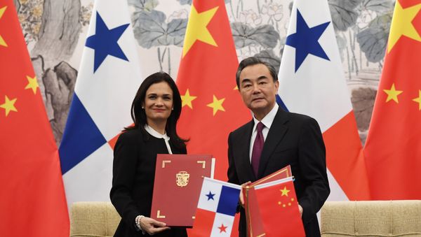 Panama's Vice President and Foreign Minister Isabel de Saint Malo (L) and Chinese Foreign Minister Wang Yi pose with their documents after signing a joint communique on establishing diplomatic relations, in Beijing, China on June 13, 2017 Panama's Vice President and Foreign Minister Isabel de Saint Malo (L) and Chinese Foreign Minister Wang Yi pose with their documents after signing a joint communique on establishing diplomatic relations, in Beijing, China on June 13, 2017 - Sputnik International